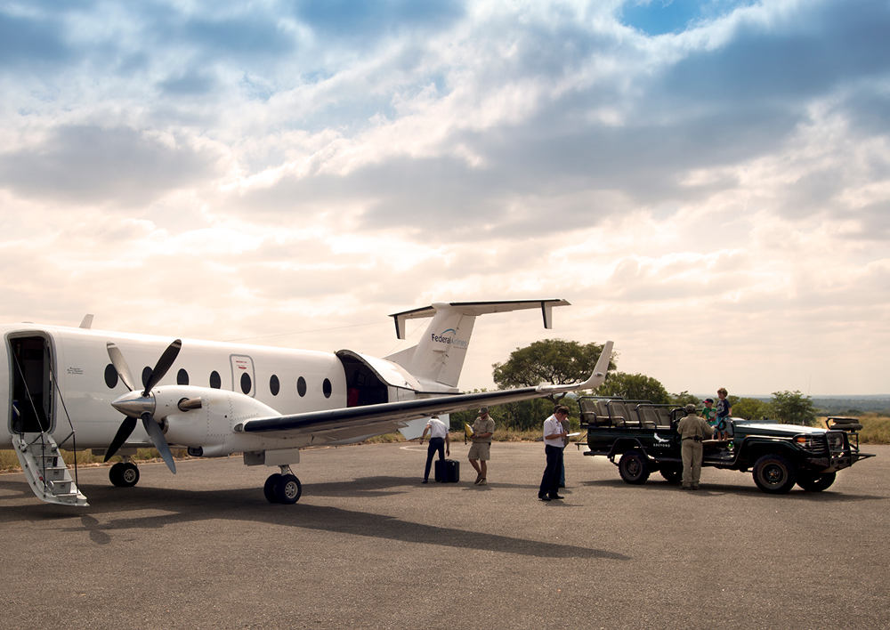 Guests arriving off a charter flight for a luxury safari