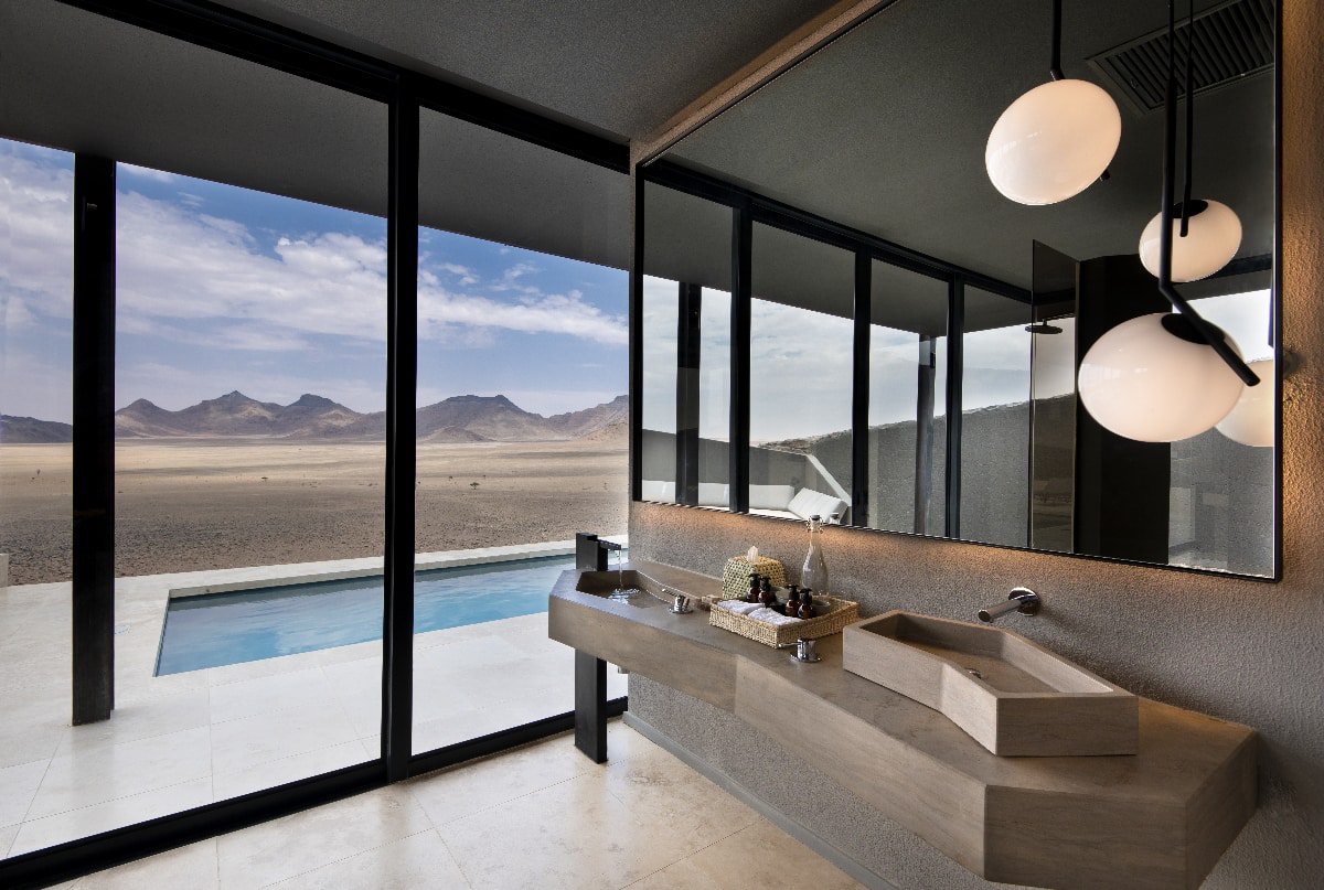 Floor-to-ceiling windows showing the Sossusvlei Desert 