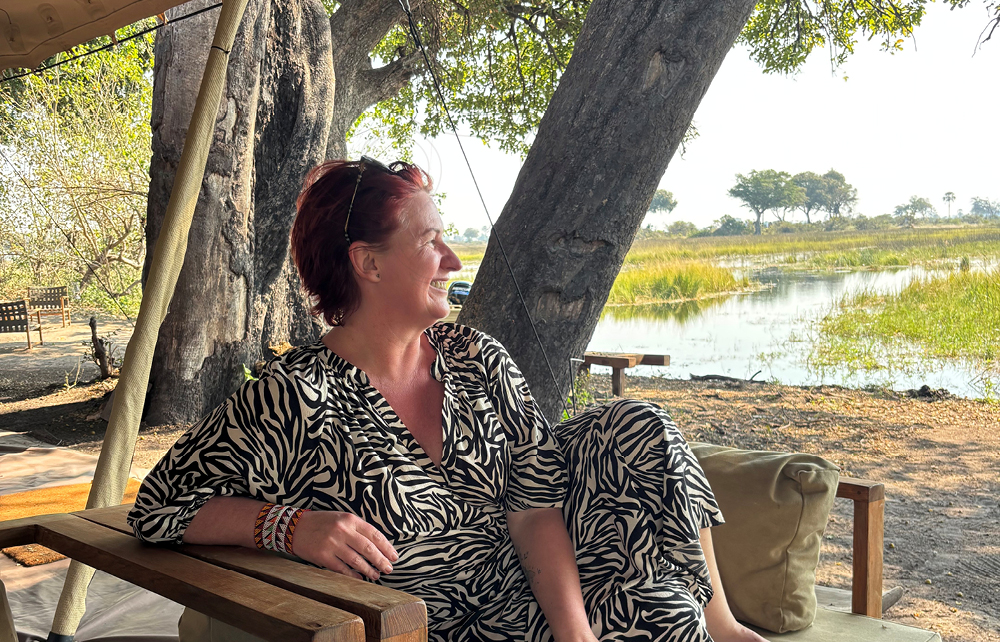 African Safari Consultants travel designer Liesl Matthews relaxing beside the Okavango Delta during safari in Botswana.